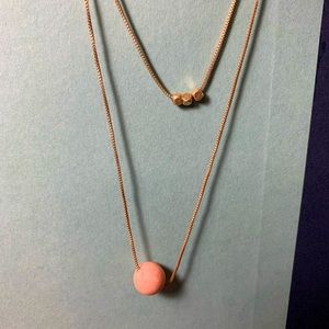 Two chain necklace, peach colored ball, 3 gold charms